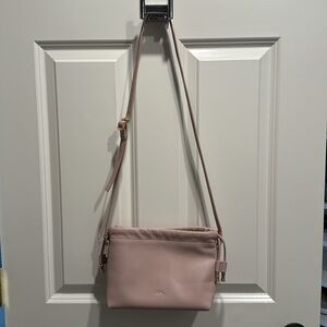 A.P.C. Cross body, blush pink color bag with rose gold hardware.